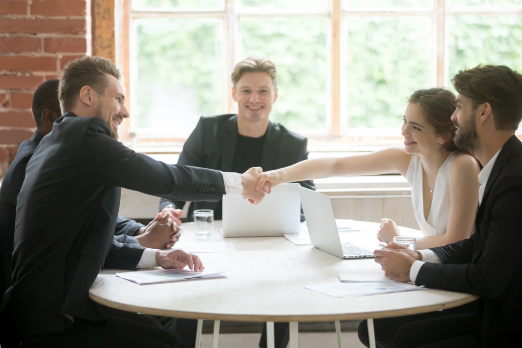 male and female executive shaking hands